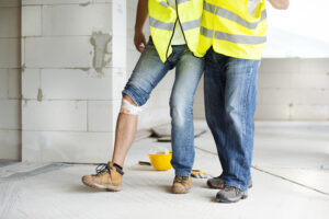 a construction worker helping his coworker after a construction accident in Seattle, WA